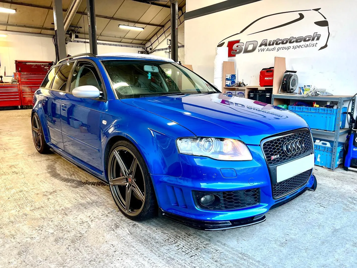a blue car is parked in a garage