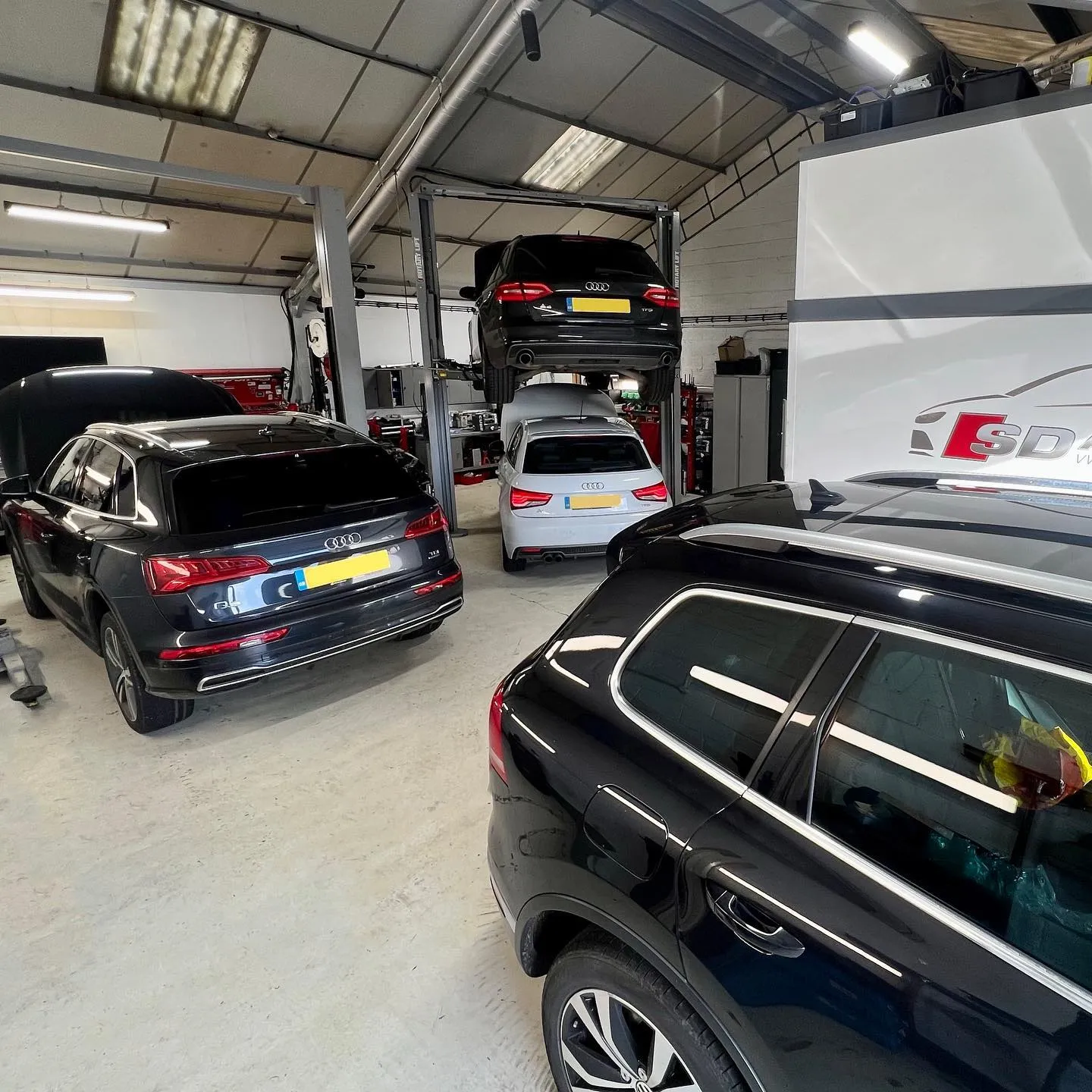 a garage with several cars parked in it